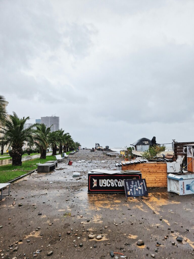 Destruction on a city street after a severe storm with fallen signs and debris